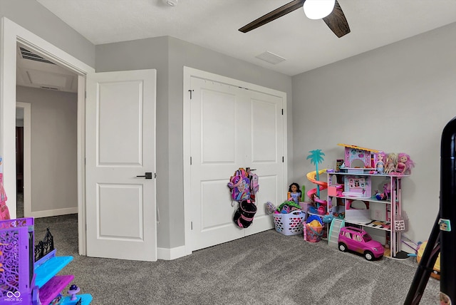 playroom featuring carpet flooring, a ceiling fan, baseboards, and visible vents