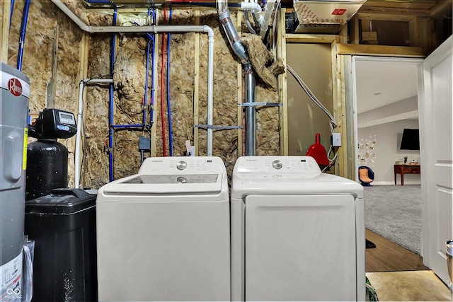 laundry room featuring laundry area, washer and clothes dryer, and wood finished floors