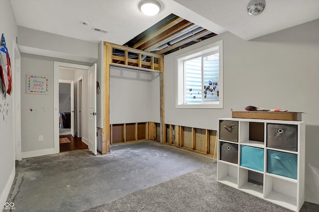 unfurnished bedroom with unfinished concrete floors, a closet, and visible vents