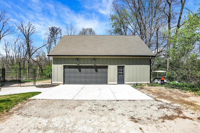 detached garage featuring fence
