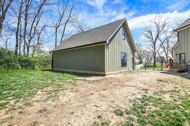 view of outbuilding with fence and a gate