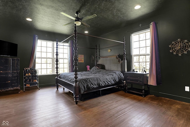 bedroom with a textured ceiling, a ceiling fan, recessed lighting, and wood finished floors
