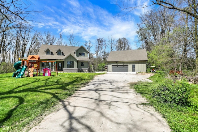 new england style home with an outbuilding, a front lawn, a playground, and a garage