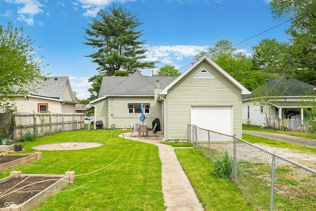 rear view of house featuring a fenced backyard, a patio area, a yard, and driveway