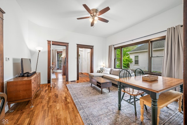 dining area featuring ceiling fan and light wood finished floors