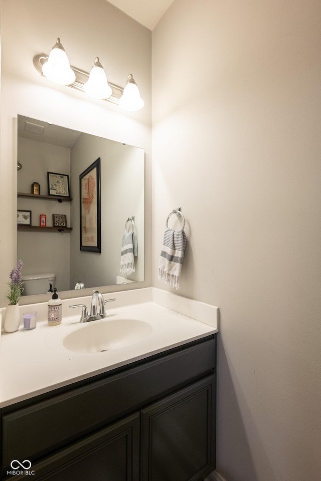 bathroom with vanity and toilet