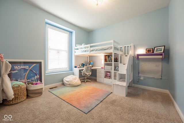 bedroom with carpet floors and baseboards