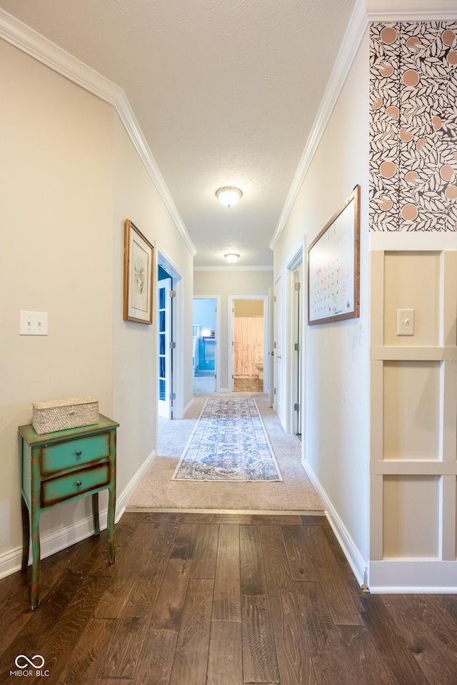 hallway featuring wood-type flooring, baseboards, ornamental molding, and built in shelves