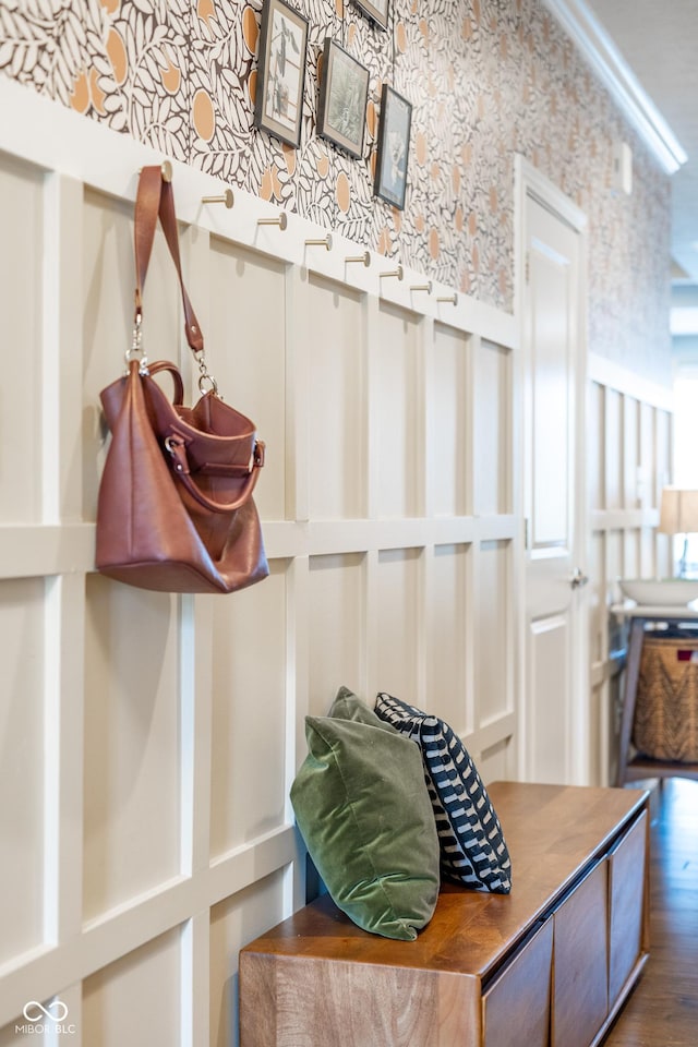 mudroom with wallpapered walls and wood finished floors