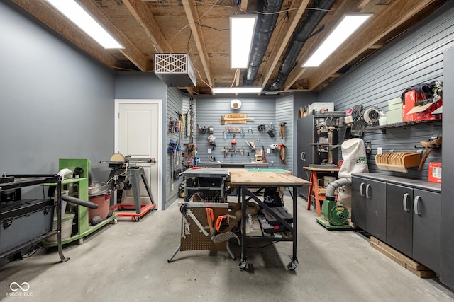 interior space featuring concrete flooring and a workshop area