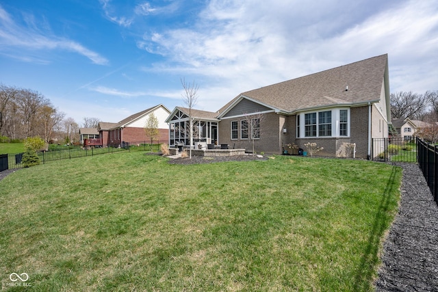 back of house with a lawn, a sunroom, brick siding, a fenced backyard, and a patio