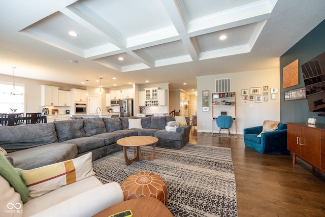 living area with crown molding, beamed ceiling, dark wood-style floors, and coffered ceiling