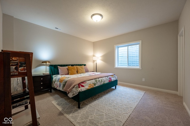 carpeted bedroom with visible vents and baseboards