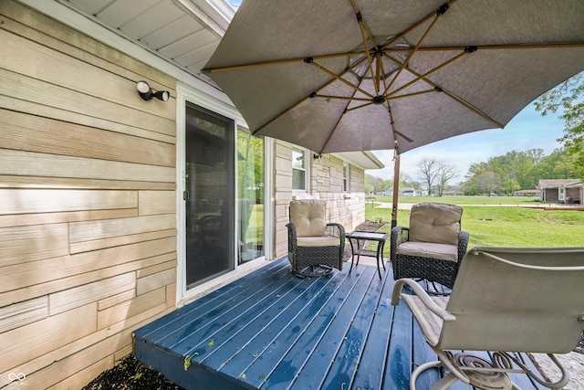 wooden deck with a lawn