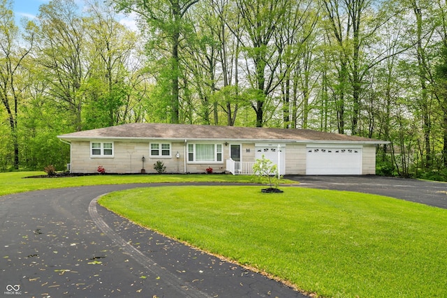ranch-style house featuring a garage, driveway, and a front yard