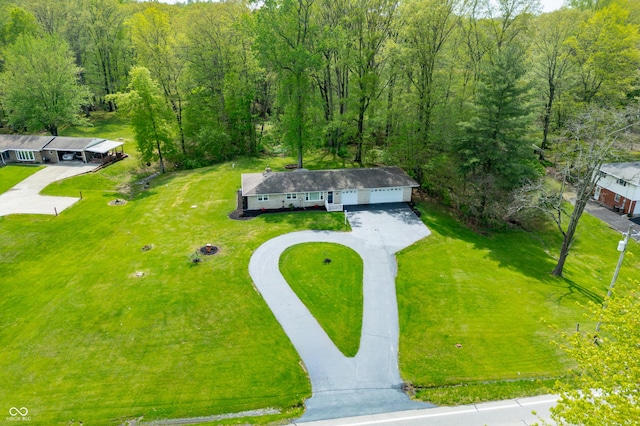 birds eye view of property featuring a wooded view