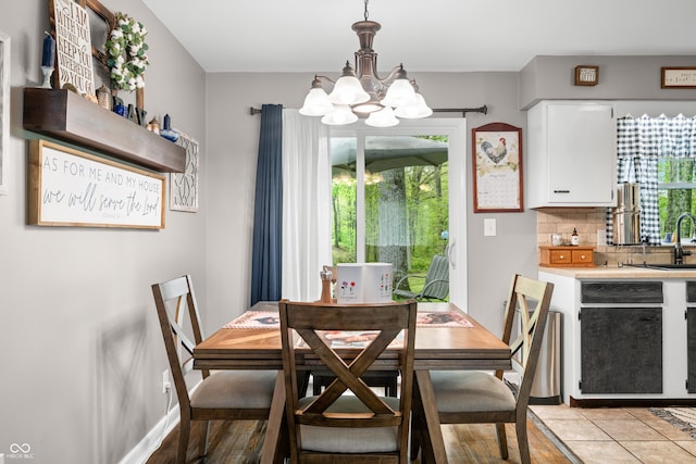 dining area featuring baseboards and a notable chandelier