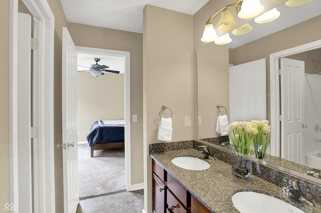 bathroom with double vanity, a chandelier, ensuite bathroom, baseboards, and a ceiling fan