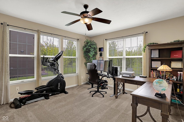 office space featuring healthy amount of natural light, carpet floors, baseboards, and ceiling fan
