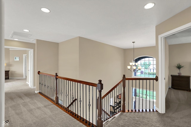 corridor featuring carpet floors, an upstairs landing, recessed lighting, a chandelier, and baseboards