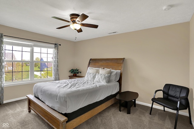 carpeted bedroom featuring baseboards and ceiling fan