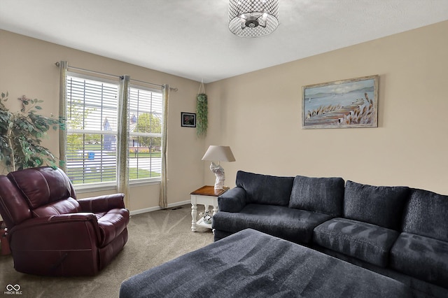 living area featuring carpet floors and baseboards