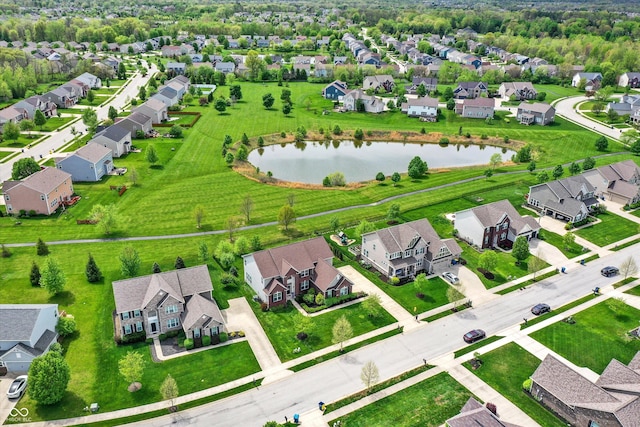aerial view of residential area featuring a nearby body of water