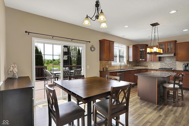 dining area with a chandelier, light wood-style floors, and recessed lighting