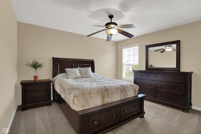 bedroom with light colored carpet, baseboards, and a ceiling fan