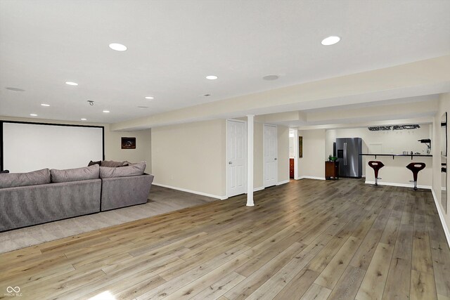 living room with hardwood / wood-style floors, recessed lighting, and baseboards