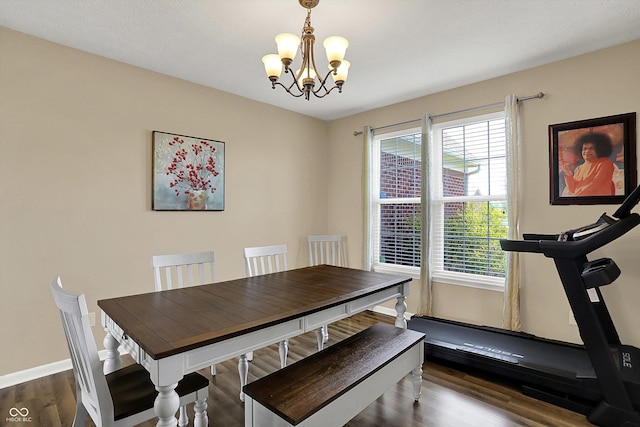 dining area with a chandelier, plenty of natural light, dark wood-type flooring, and baseboards