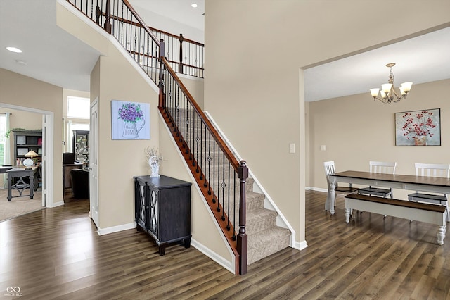 stairway featuring wood finished floors, a chandelier, recessed lighting, and baseboards