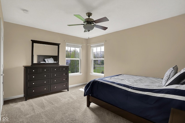 bedroom with light carpet, baseboards, and ceiling fan