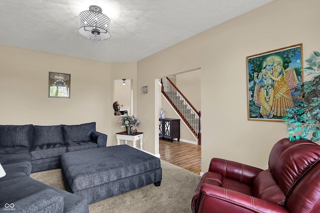living room with stairs and wood finished floors