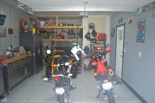 garage featuring a garage door opener and a workshop area