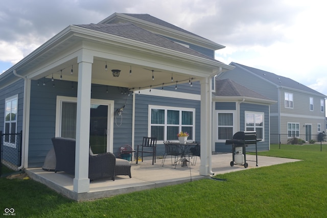 rear view of house featuring a yard and a patio area