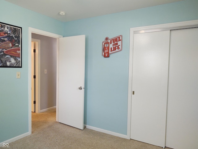 2630 Wedgewood Dr, Columbus, IN 47203 - unfurnished bedroom with a closet, baseboards, and light carpet
