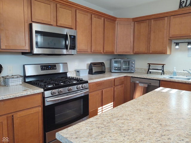 2630 Wedgewood Dr, Columbus, IN 47203 - kitchen with brown cabinets, appliances with stainless steel finishes, a sink, and a toaster
