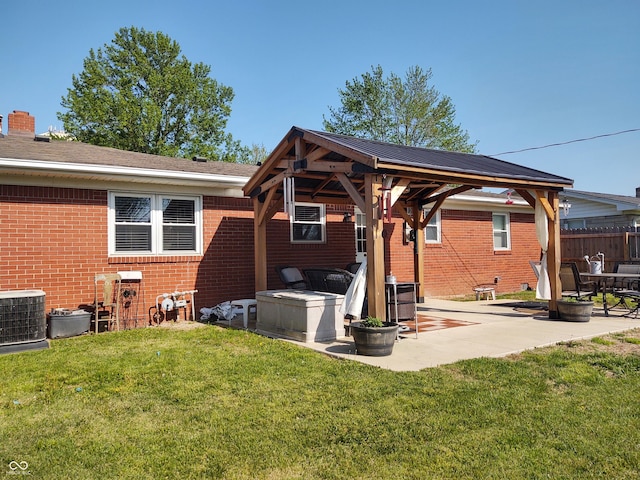 2630 Wedgewood Dr, Columbus, IN 47203 - back of property with a gazebo, brick siding, cooling unit, a patio area, and a lawn