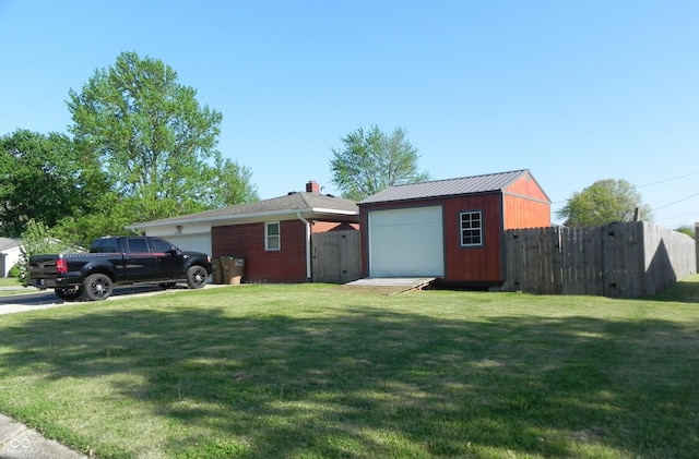 2630 Wedgewood Dr, Columbus, IN 47203 - exterior space with fence, an outdoor structure, and a garage
