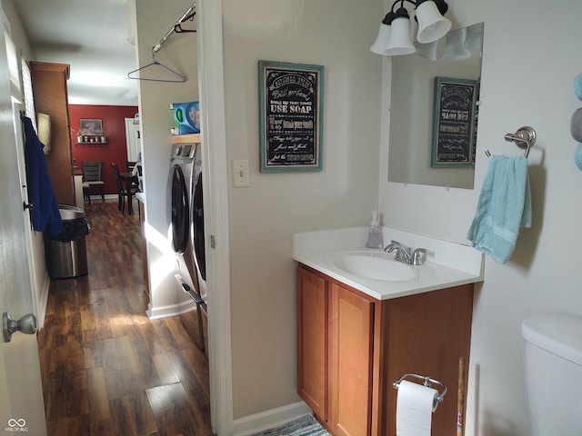 2630 Wedgewood Dr, Columbus, IN 47203 - bathroom with vanity, separate washer and dryer, toilet, baseboards, and wood finished floors