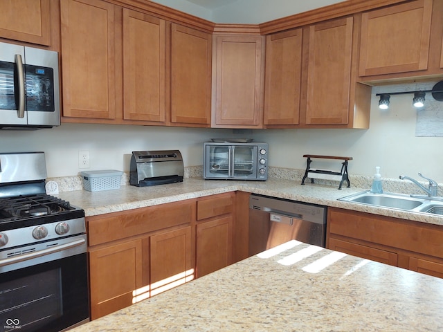 2630 Wedgewood Dr, Columbus, IN 47203 - kitchen featuring brown cabinets, appliances with stainless steel finishes, and a sink
