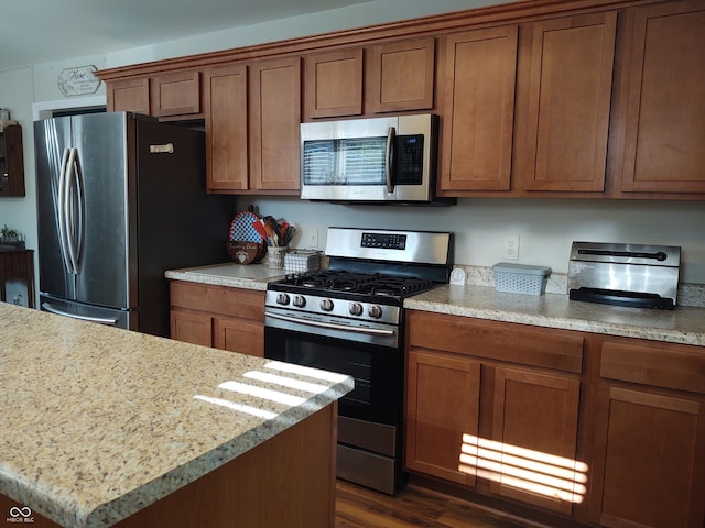 2630 Wedgewood Dr, Columbus, IN 47203 - kitchen featuring brown cabinets, appliances with stainless steel finishes, and dark wood-type flooring