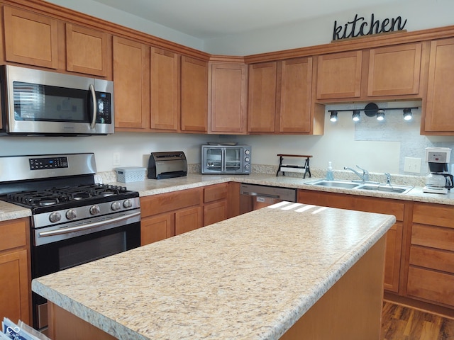 2630 Wedgewood Dr, Columbus, IN 47203 - kitchen featuring light countertops, a kitchen island, stainless steel appliances, and a sink