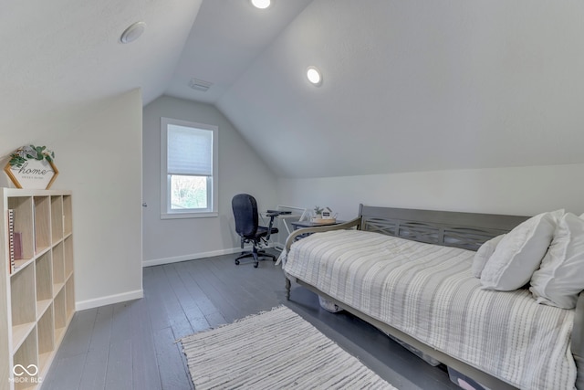 bedroom with wood-type flooring, baseboards, vaulted ceiling, and visible vents