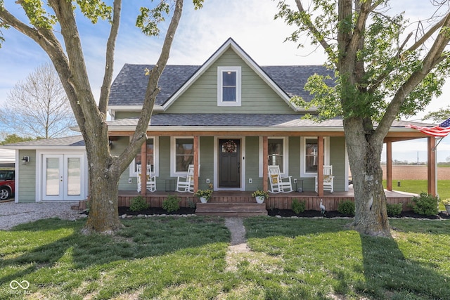 view of front facade with a shingled roof, french doors, a front lawn, and covered porch