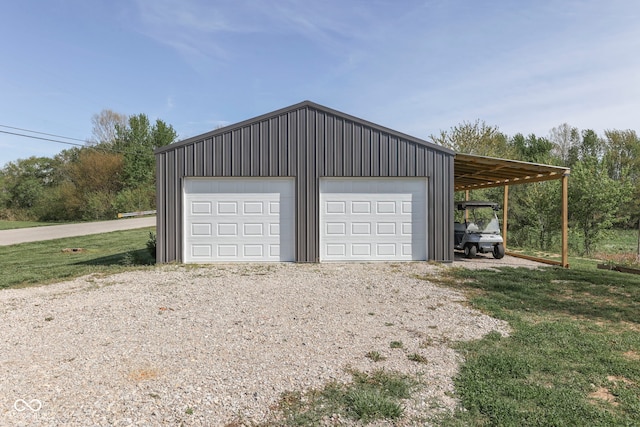 garage with gravel driveway and a garage