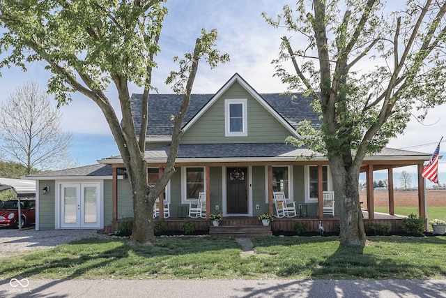 view of front of home featuring a porch, a shingled roof, french doors, and a front yard