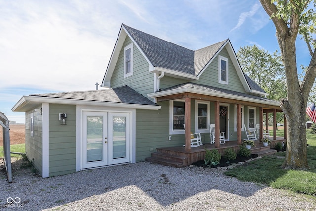 craftsman house with a porch, roof with shingles, and french doors
