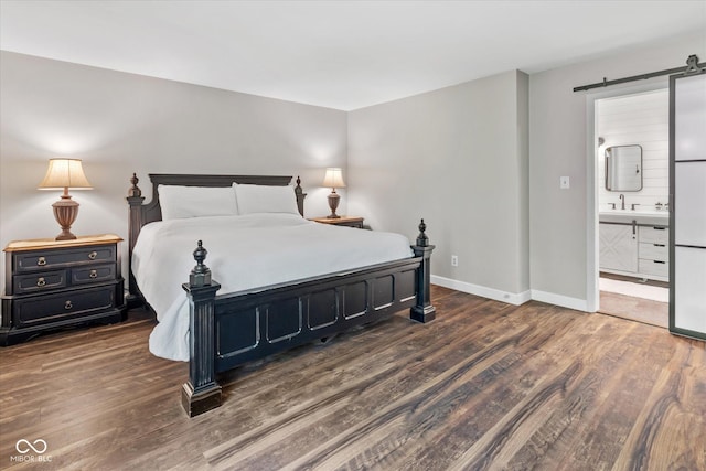 2450 S US-421, Zionsville, IN 46077 - bedroom with baseboards, a sink, ensuite bath, and wood finished floors